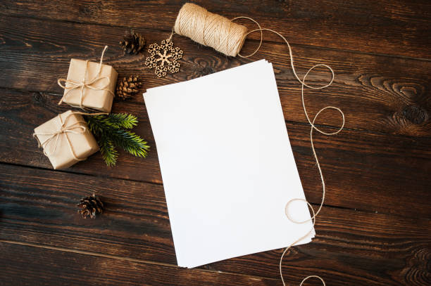 istock Mockup Christmas gift boxes and blank paper on a background and place for text 857060096