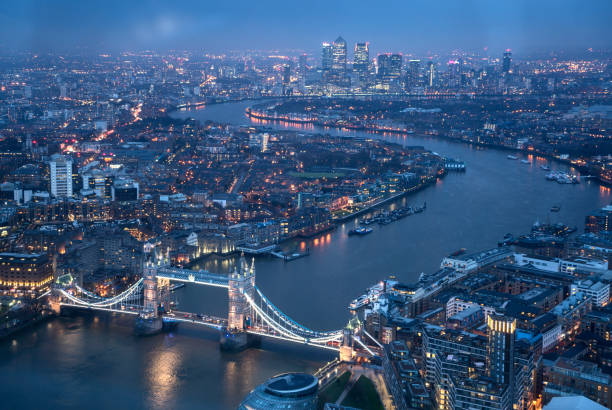 istock Aerial view over London skyline at night 857065626