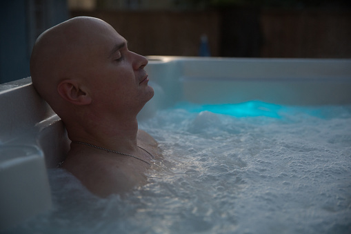Man's feet floating in a hot tub