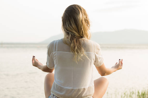 istock Young blond woman meditating 857068282