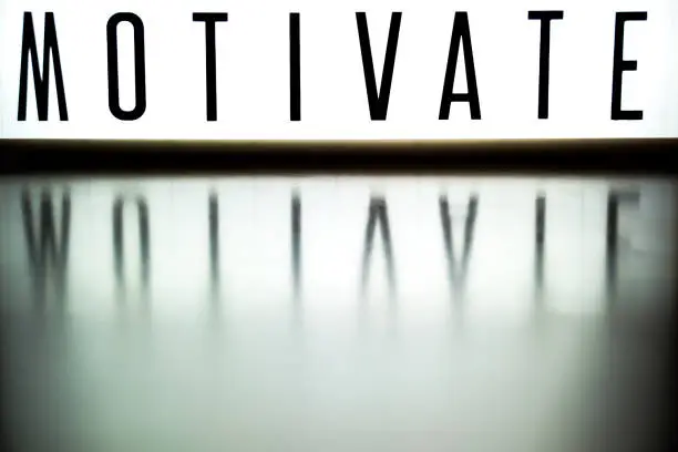 Photo of light up board displays the phrase MOTIVATE