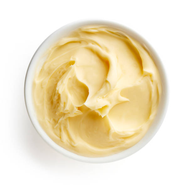 Bowl of butter isolated on white background, top view