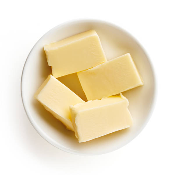 istock Butter pieces in bowl isolated on white background, top view 857074946