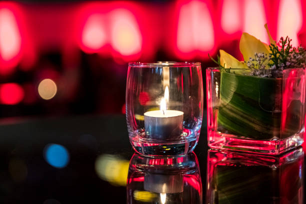 istock Burning candle in glass cup with abstract background 857075200