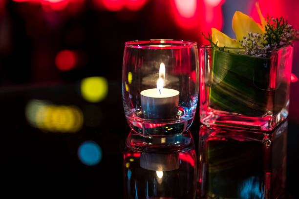 istock Burning candle in glass cup with abstract background 857075266