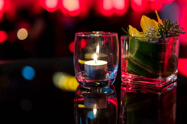 istock Burning candle in glass cup with abstract background 857075498