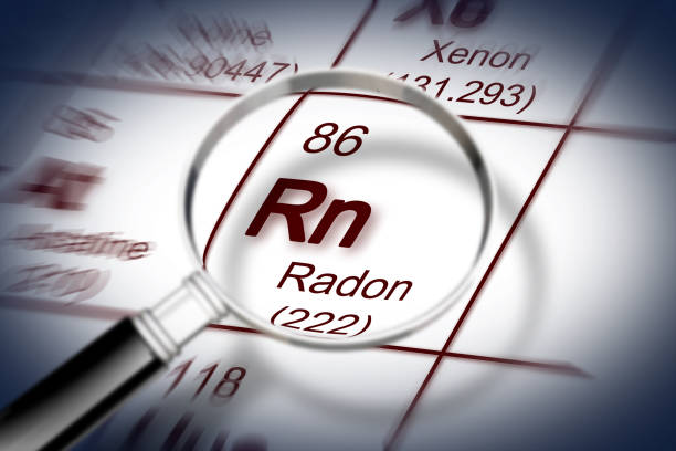 the danger of radon gas - concept image with periodic table of the elements and magnifying lens - radium imagens e fotografias de stock