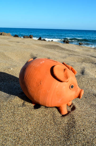 istock Piggy Bank on the Sand Beach 857076022