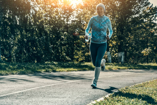 istock woman running on stadium track 857081760