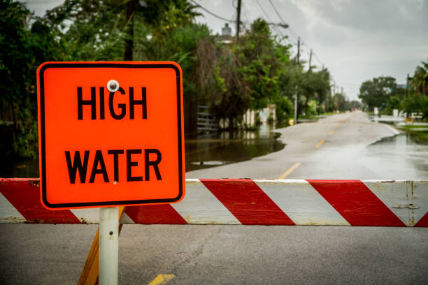 signe de hautes eaux bloquant une route près de houston au texas - harvey photos et images de collection