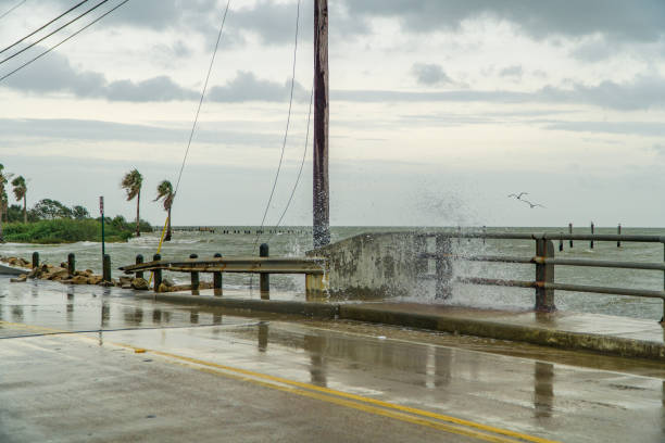 Water crashing over a road near Galveston Bay just outside of Houston Texas stock photo