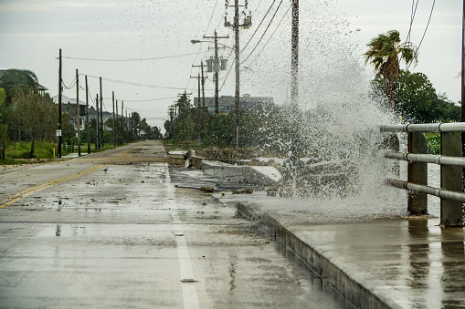 Water crashing over a road near Galveston Bay just outside of Houston Texas