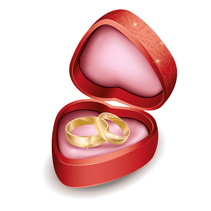 Wedding rings in red box at shape of heart