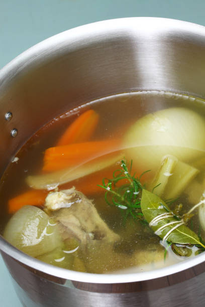 istock making chicken soup stock (bouillon) in a pot 857091402