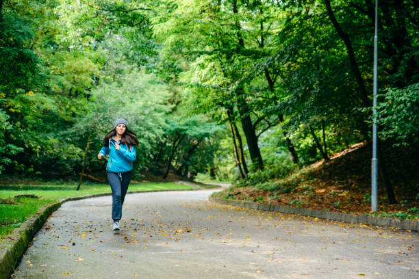 istock young pretty woman run utside in the park 857095178