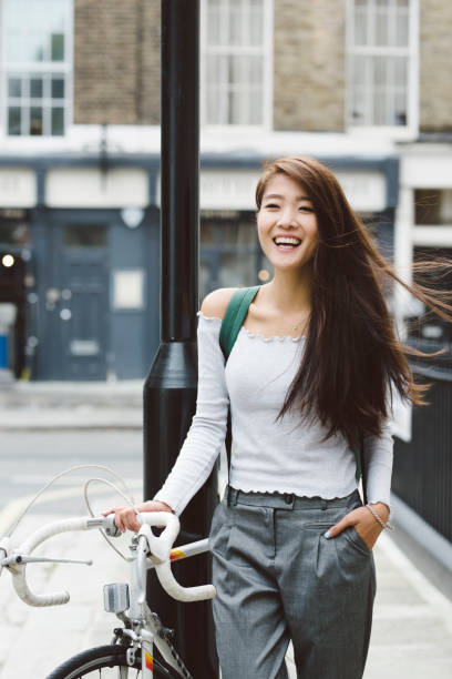 istock Asian Student Holding Bicycle Wind in Hair 857097598