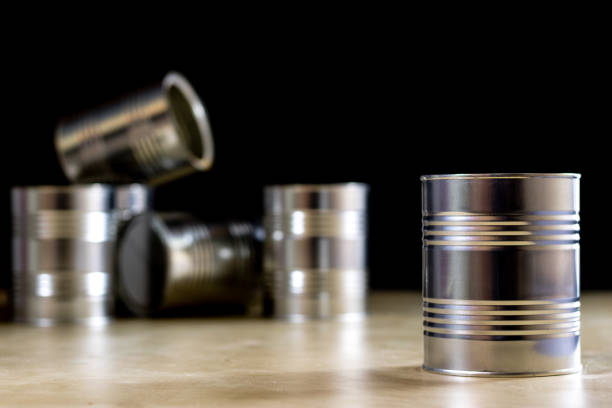 istock Paint tins set on a workshop table. Table with light wood, black background 857099060
