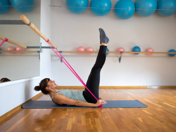 istock Woman exercising with a resistance band 857099108