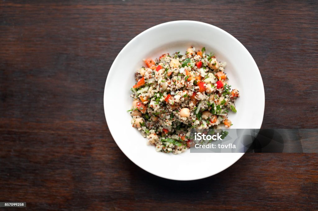 Quinoa Salad Healthy quinoa salad with chickpeas, bell peppers, cucumbers, onions and parsley. Quinoa Stock Photo