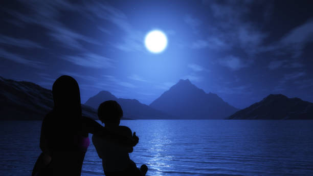istock 3D mother and son looking out to the ocean at night 857100382