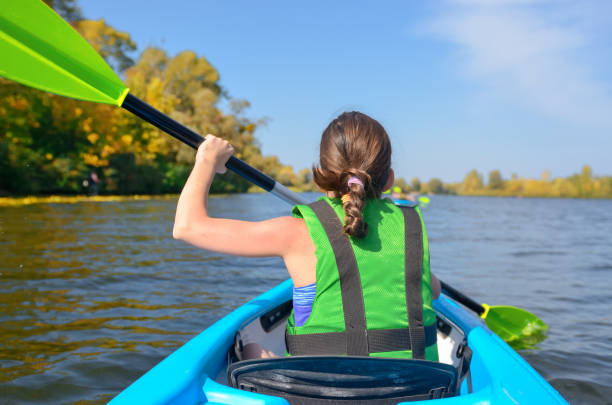 family kayaking, child paddling in kayak on river canoe tour, kid on active summer weekend and vacation, sport and fitness concept - family kayaking kayak canoeing imagens e fotografias de stock