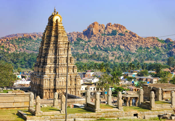 Panorama of Hampi, view of the Virupaksha temple Virupaksha Temple, located in the ruins of ancient city Vijayanagar at Hampi, India. Landscape with unique mountain formation, tropical nature on the horizon and old hindu temple. virupaksha stock pictures, royalty-free photos & images