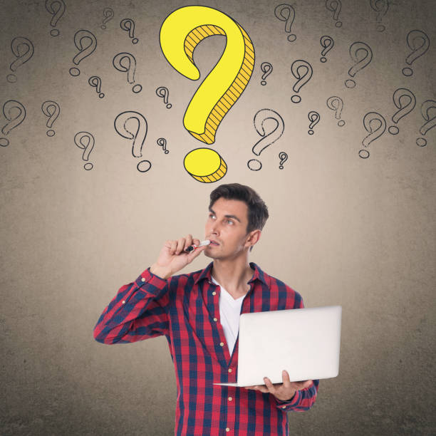 istock Thoughtful man holding laptop and felt tip pen 857106736