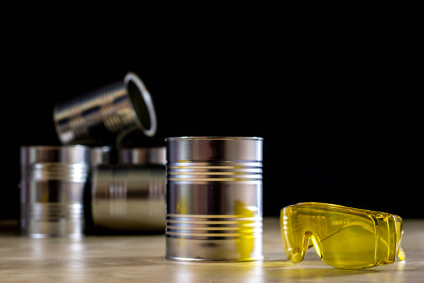 istock Paint tins set on a workshop table. Table with light wood, black background 857106748