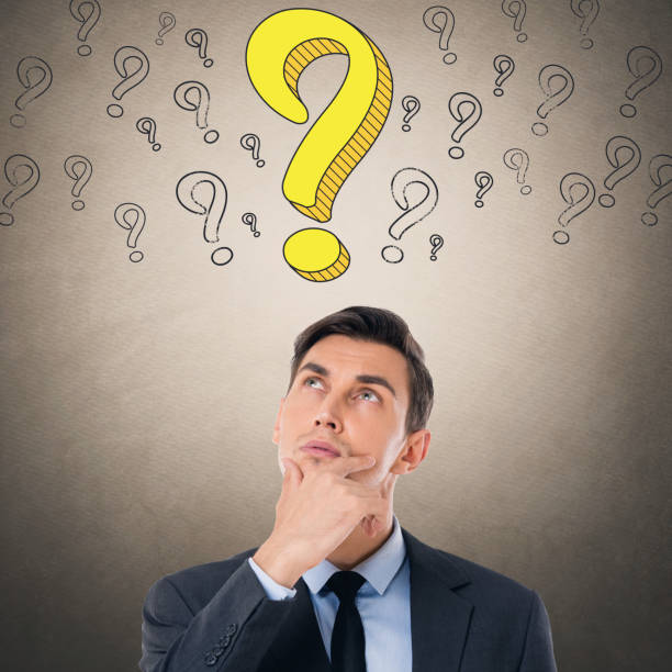 istock Thoughtful businessman looking up at question mark 857106812