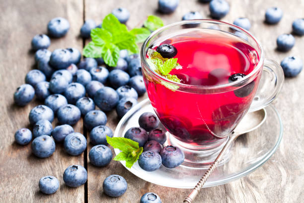 istock blueberry  tea with mint leaves on wooden background 857116694