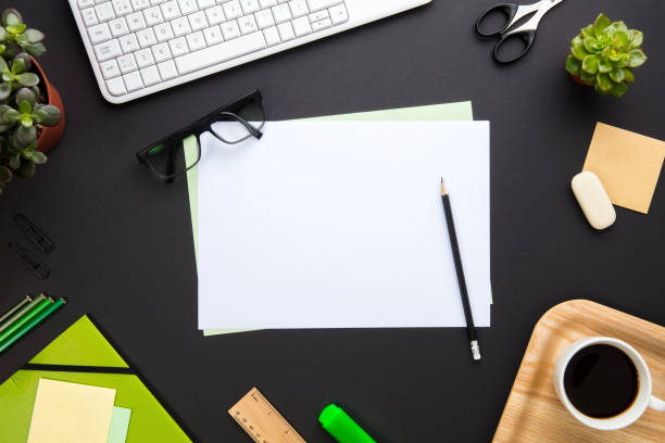 istock Blank Documents Surrounded By Office Supplies On Gray Desk 857121280