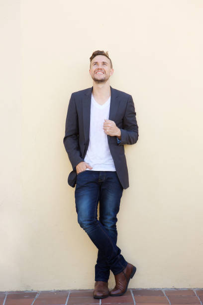 istock Full length smiling young man looking up 857125764