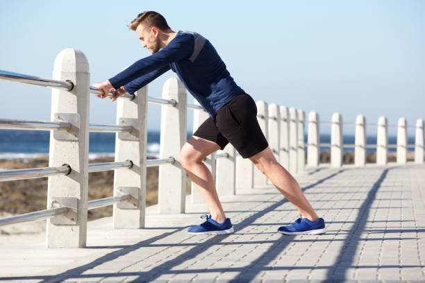 istock healthy young man stretching outside for exercise 857125928