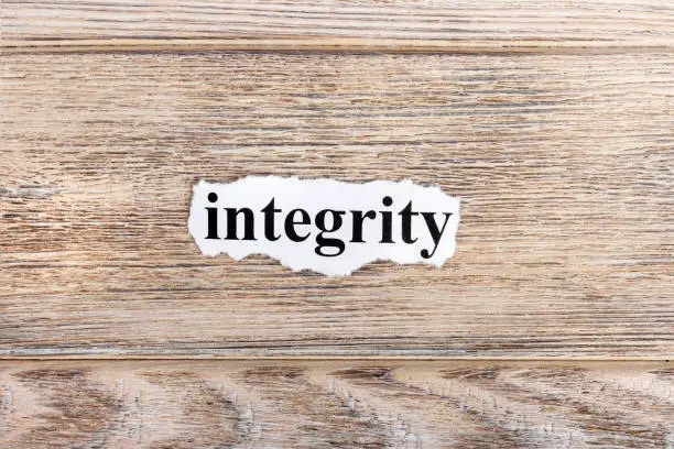 Photo of Integrity text on paper. Word Integrity on torn paper. Concept Image