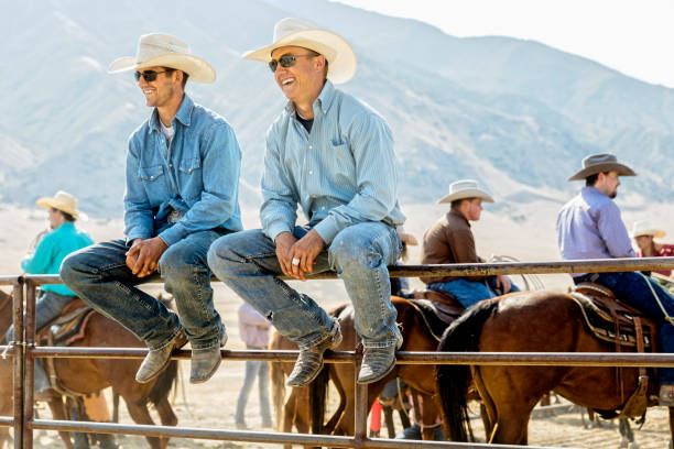 Two young cowboys enjoy a get together with other cowboys