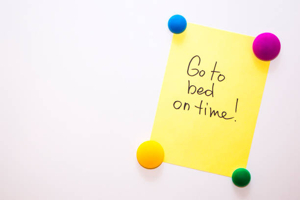 istock Fridge note with the text about wellness: Go to bed on time! 857126538