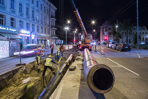 Riga, Latvia - August 9, 2016: Heat pipe replacement works on Brivibas Street at night