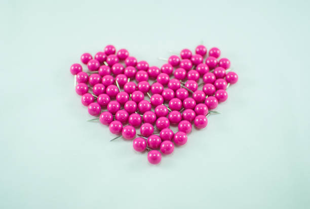 istock Collection of pink push pins. Heart shape 857138602