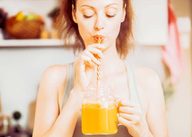Fit woman drinking fresh smoothie drink