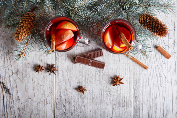 istock Lemon tea with chocolate and pine branch on a table background. Tea and sweets. Christmas eve concept. 857148486