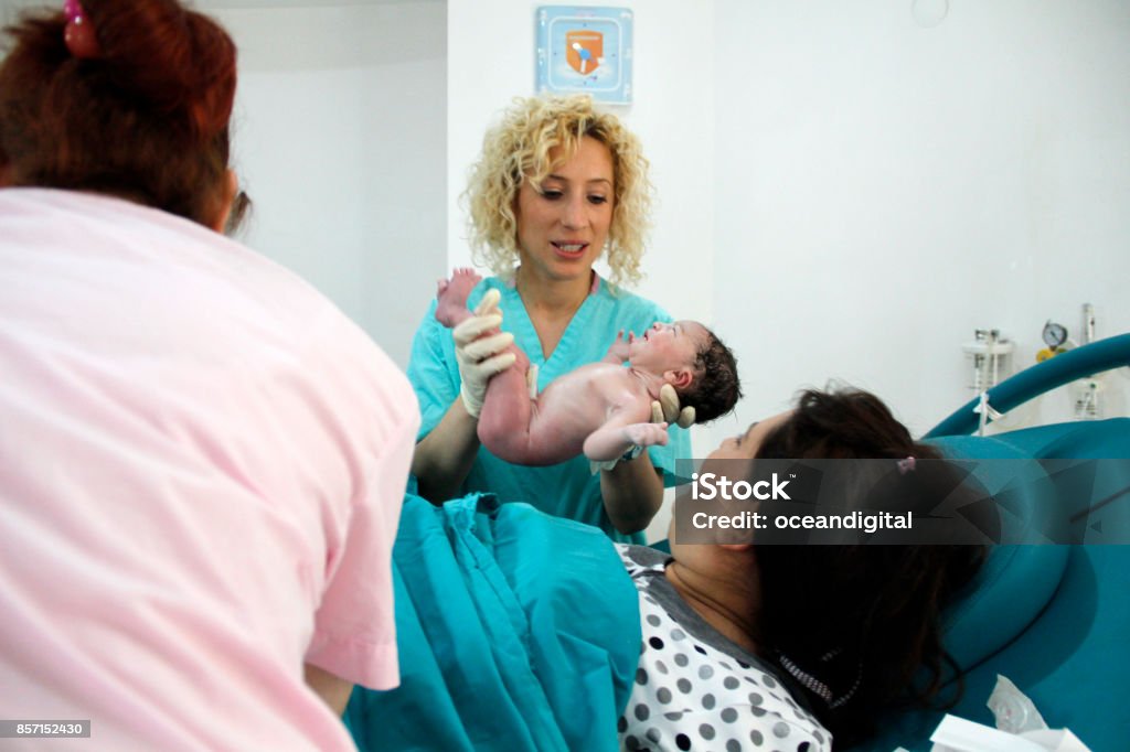 Mother and newborn in hospital Newborn girl baby in hospital with nurse Midwife Stock Photo