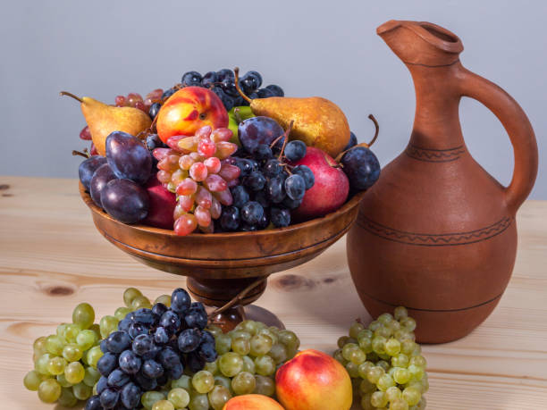 istock autumnal fruit still life with Georgian jug on rustic wooden table background 857156740