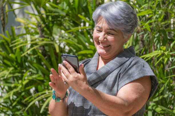 istock Elderly woman using a mobile phone 857164328
