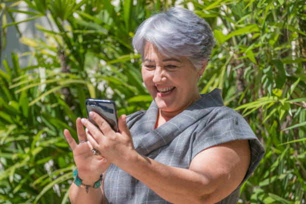 istock Elderly woman using a mobile phone 857164386