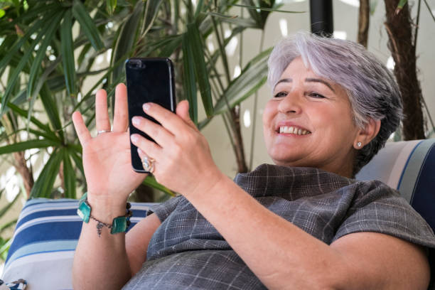 istock Elderly woman using a mobile phone 857164412