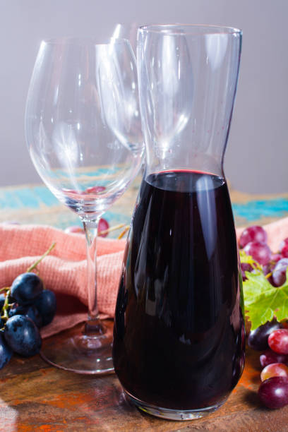 istock Small carafe with dry red wine, two wine glasses and grapes 857165328