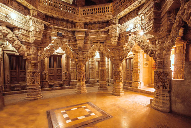 istock Columns with stone reliefs in Indian temple wall. Ancient architecture example with Jain motifs, Jaisalmer of India. 857170480