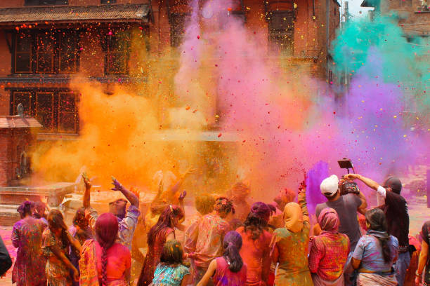 Holi Festival Bhaktapur, Nepal - March 12, 2014: Group of people celebrating the festival of colors Holi which is very famous in Nepal and India central asian ethnicity photos stock pictures, royalty-free photos & images