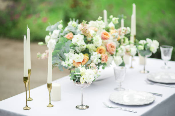 istock decorated wedding table for two with beautiful flower composition, glasses for wine, candles and plates, outdoor, fine art. 857173818