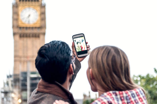Couple take a selfie at Big ben in London Couple take a selfie at Big ben in London big ben stock pictures, royalty-free photos & images